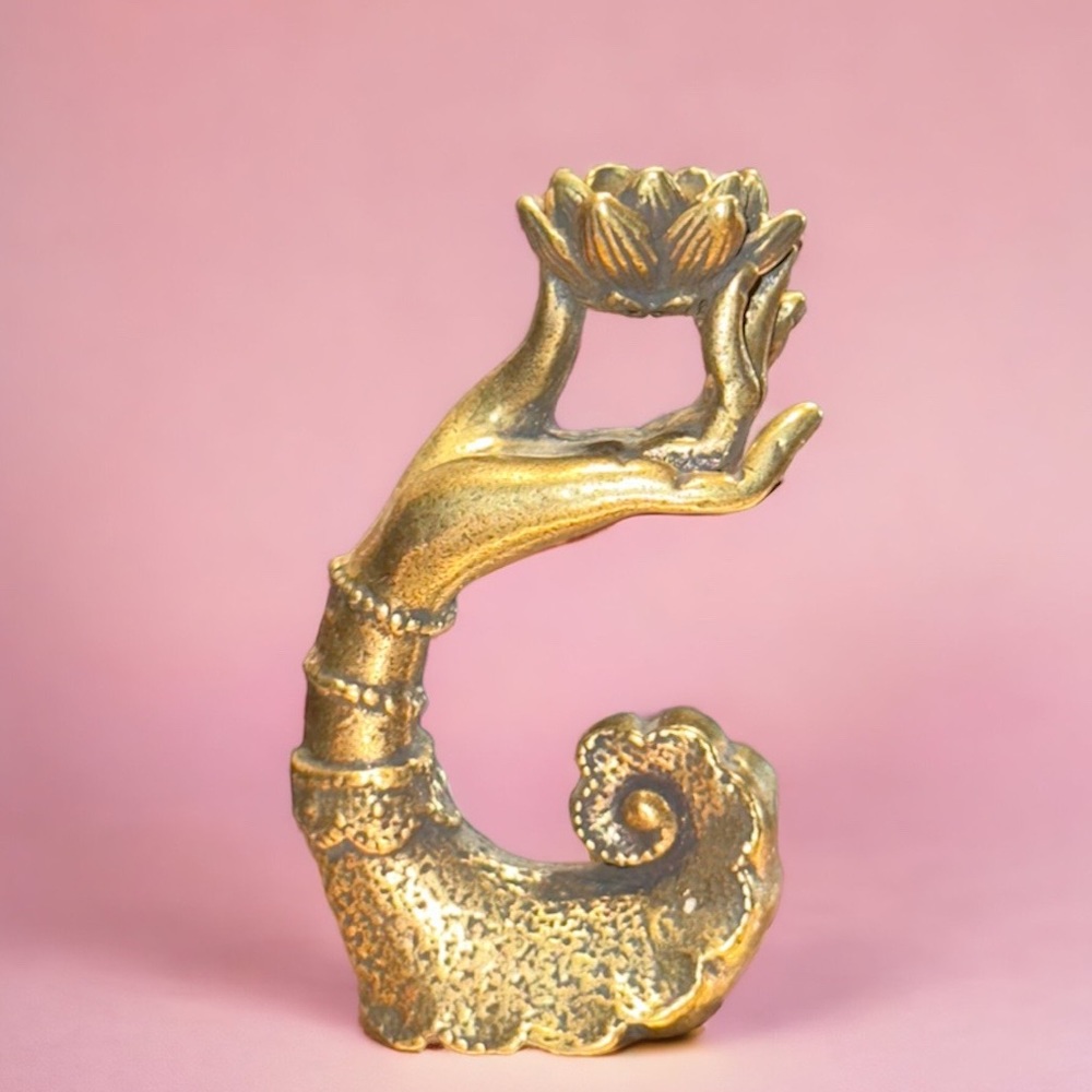 Hand holding lotus flower incense holder